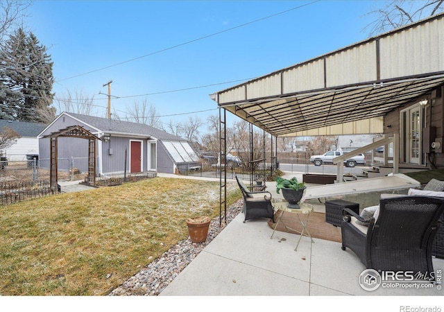 view of patio / terrace featuring an outbuilding and fence