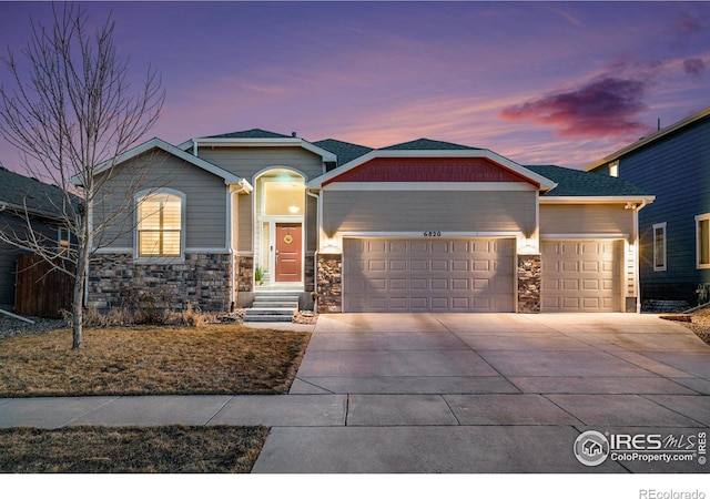 craftsman inspired home with concrete driveway, an attached garage, and stone siding