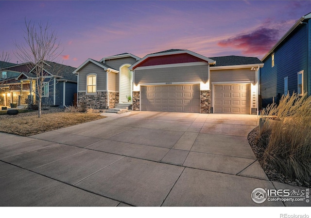 craftsman inspired home featuring stone siding, concrete driveway, and an attached garage