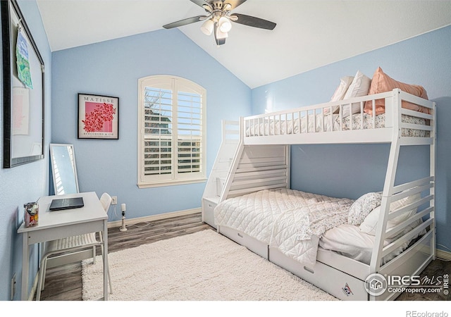 bedroom with baseboards, lofted ceiling, wood finished floors, and a ceiling fan