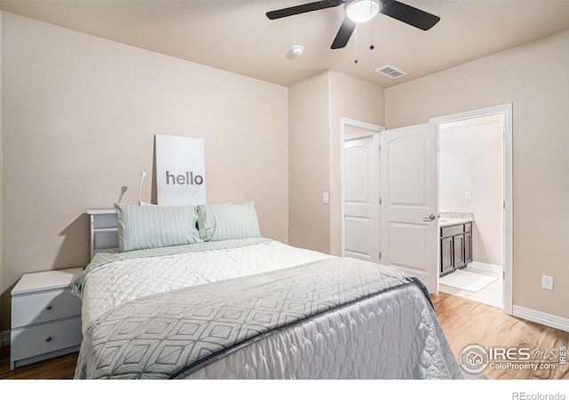 bedroom featuring visible vents, connected bathroom, baseboards, ceiling fan, and light wood-type flooring