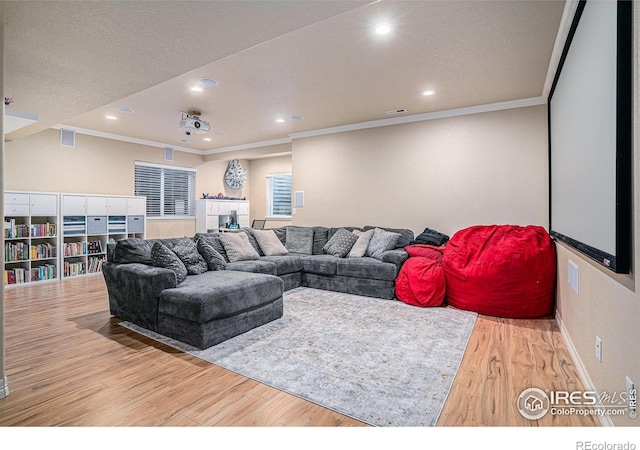 living room featuring recessed lighting, ornamental molding, and wood finished floors