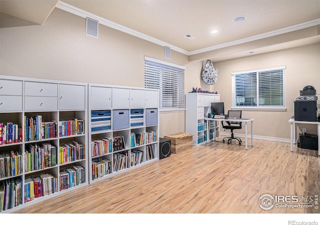 office area with visible vents, ornamental molding, baseboards, and wood finished floors