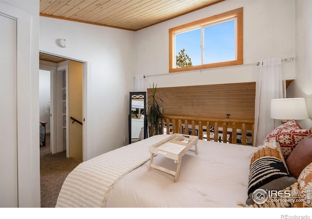 bedroom featuring wooden ceiling and carpet floors