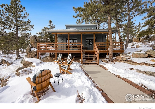 view of front of home featuring board and batten siding and a wooden deck