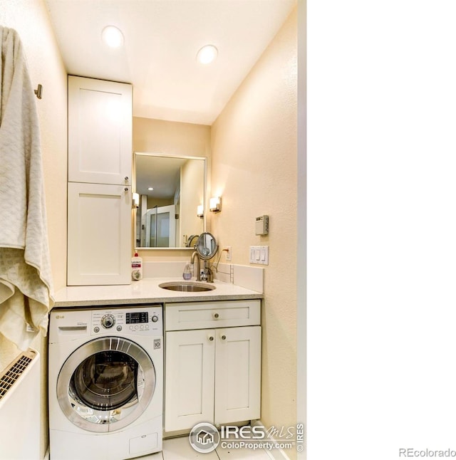 bathroom featuring washer / dryer, recessed lighting, and a sink