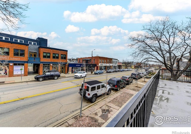 view of road with street lights, curbs, and sidewalks