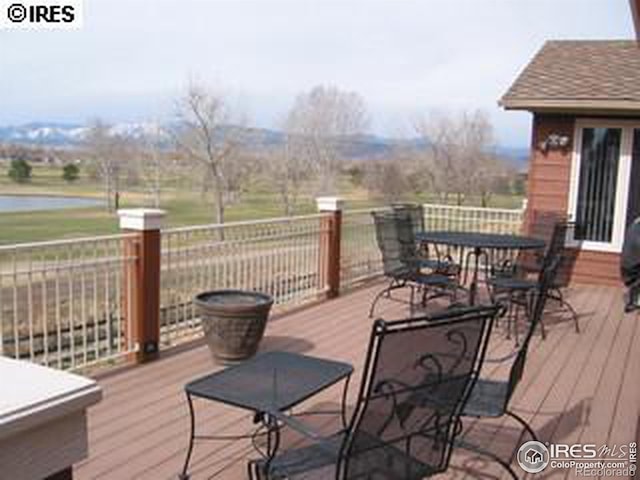 wooden deck featuring outdoor dining area