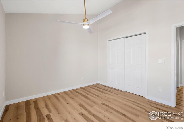 unfurnished bedroom with a ceiling fan, wood finished floors, a closet, and baseboards