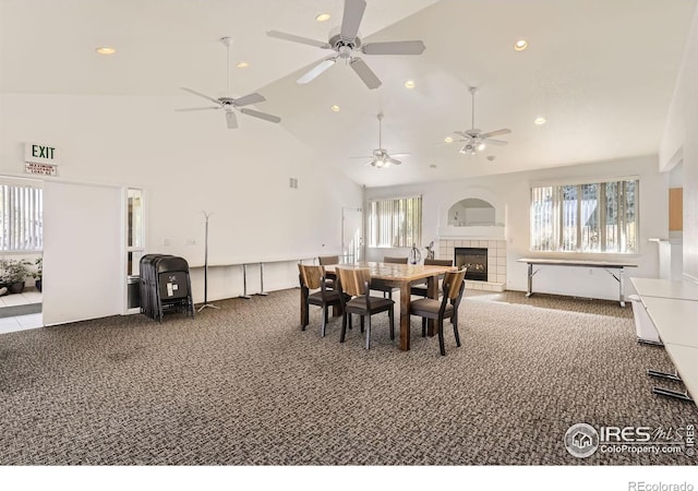 carpeted dining space with recessed lighting, a fireplace, and high vaulted ceiling