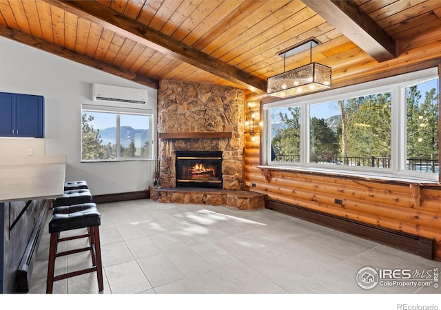 871 E Ln, Estes Park, CO 80517 - unfurnished living room with rustic walls, a wall mounted air conditioner, wood ceiling with exposed beams, plenty of natural light, and a stone fireplace