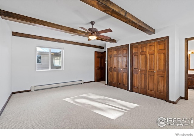 871 E Ln, Estes Park, CO 80517 - unfurnished bedroom featuring a baseboard radiator, carpet floors, baseboards, beam ceiling, and two closets