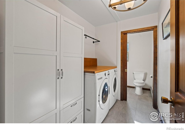 871 E Ln, Estes Park, CO 80517 - laundry room with washer and dryer, light tile patterned floors, and baseboards