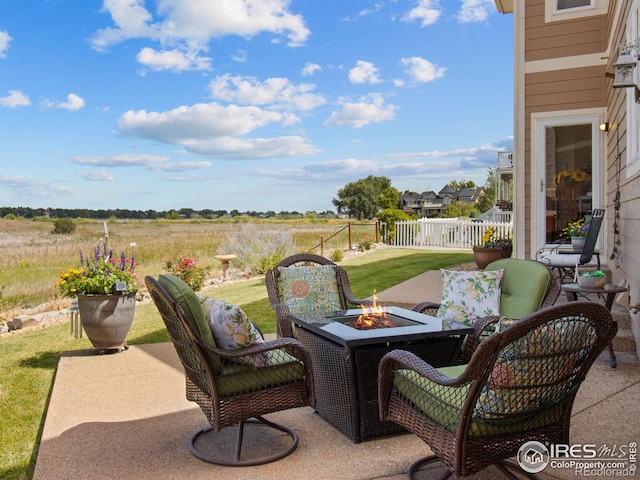 view of patio with a fire pit and fence