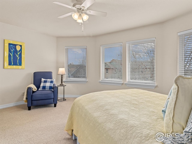 carpeted bedroom featuring a ceiling fan and baseboards