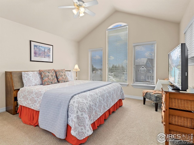 bedroom with light colored carpet, baseboards, and vaulted ceiling