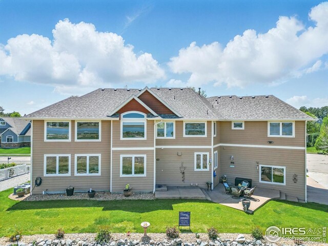 3916 Fowler Ln, Longmont, CO 80503 - back of property with a patio area, a yard, and a shingled roof