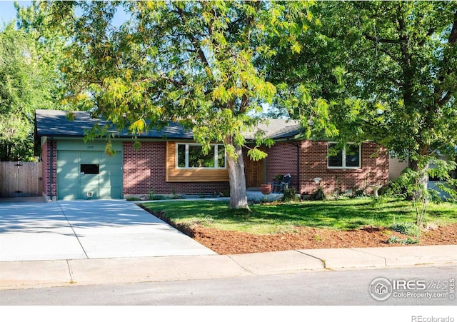 ranch-style home with brick siding, driveway, a front yard, and a garage