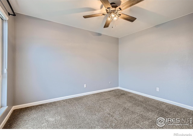 carpeted empty room with a ceiling fan and baseboards