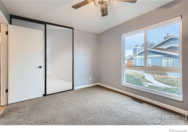 unfurnished bedroom with visible vents, baseboards, carpet, and ceiling fan