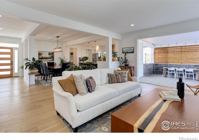 living area featuring recessed lighting and light wood-style floors