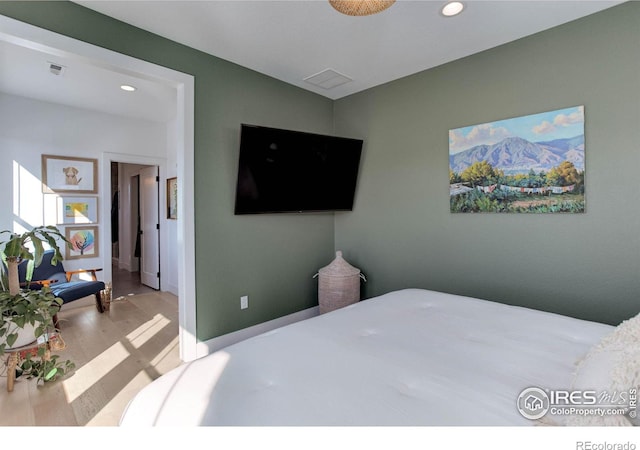 bedroom featuring recessed lighting, visible vents, baseboards, and wood finished floors