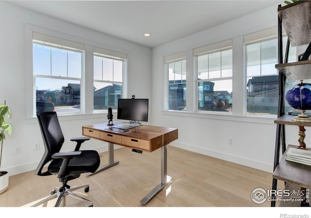 office space featuring recessed lighting, light wood-type flooring, and baseboards