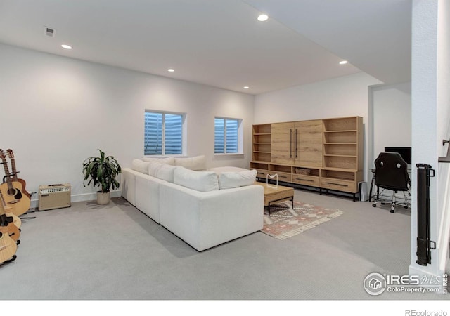 carpeted living area featuring recessed lighting and visible vents