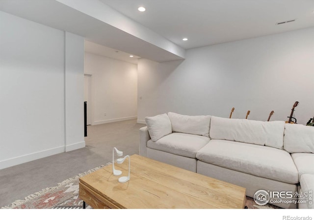 living room featuring recessed lighting, visible vents, light colored carpet, and baseboards