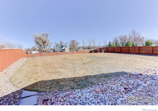 view of yard with a fenced backyard