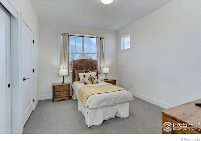 bedroom featuring a closet, baseboards, and carpet flooring