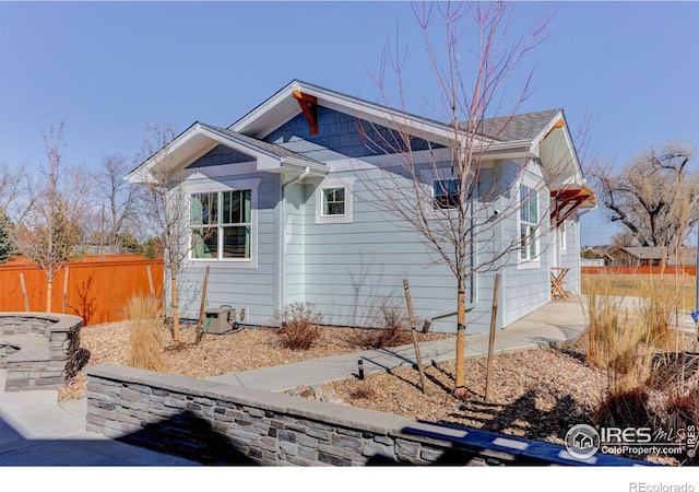 view of side of property featuring a patio area and fence