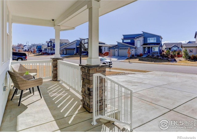 view of patio / terrace featuring a residential view and a porch