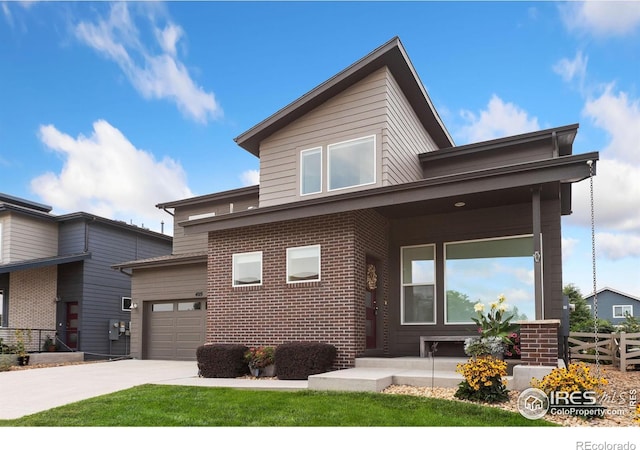 view of front of property with brick siding, fence, concrete driveway, covered porch, and a garage