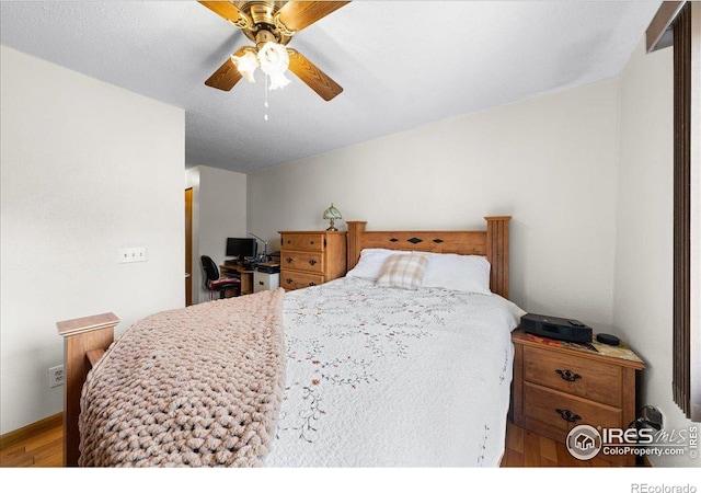 bedroom with ceiling fan and wood finished floors