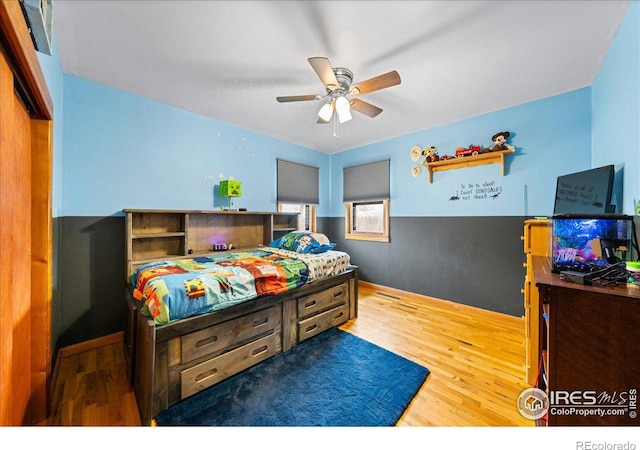 bedroom with wood finished floors and a ceiling fan