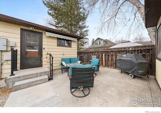 view of patio featuring area for grilling and fence