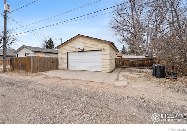 detached garage featuring fence