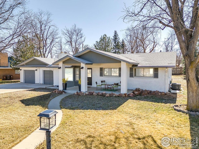 ranch-style house featuring a front yard, an attached garage, concrete driveway, central air condition unit, and brick siding