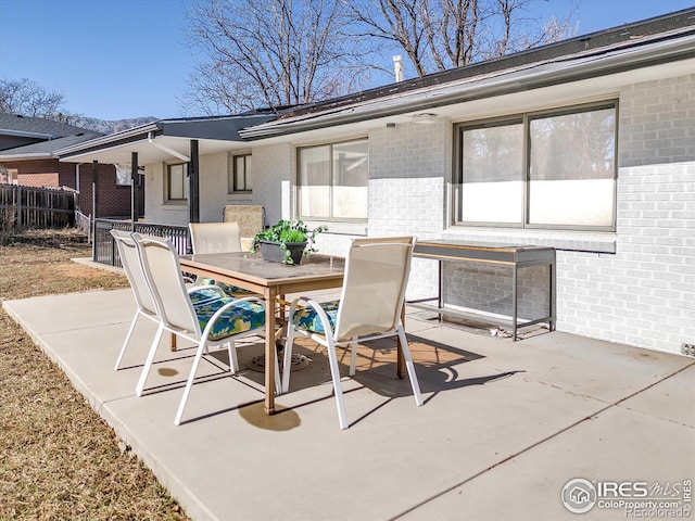 view of patio / terrace with outdoor dining area and fence