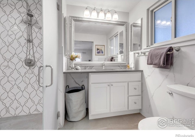 full bath with tile patterned flooring, a shower stall, vanity, and toilet