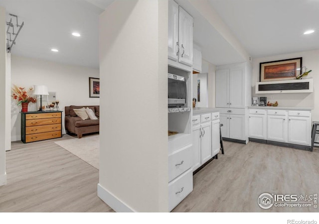 kitchen with baseboards, recessed lighting, light countertops, white cabinets, and light wood-type flooring