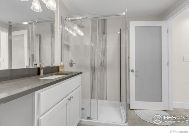 full bathroom featuring a shower stall and vanity