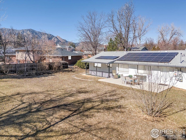 view of yard with fence, a patio area, and a mountain view