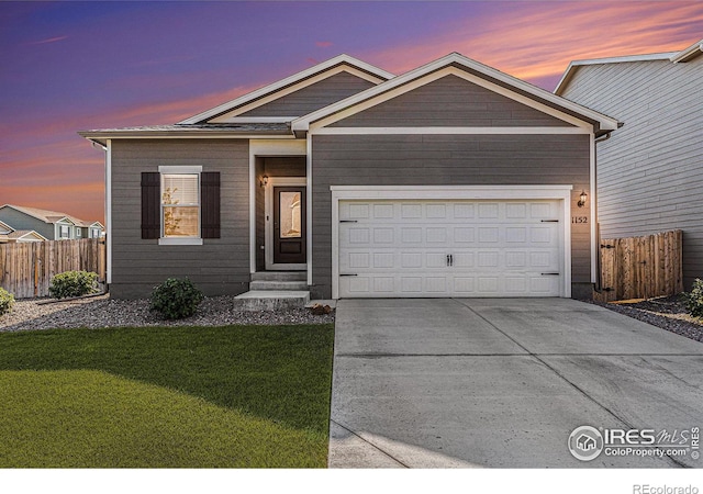 ranch-style house featuring concrete driveway, a garage, fence, and a lawn