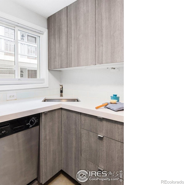 kitchen featuring a sink, modern cabinets, dishwasher, and light countertops