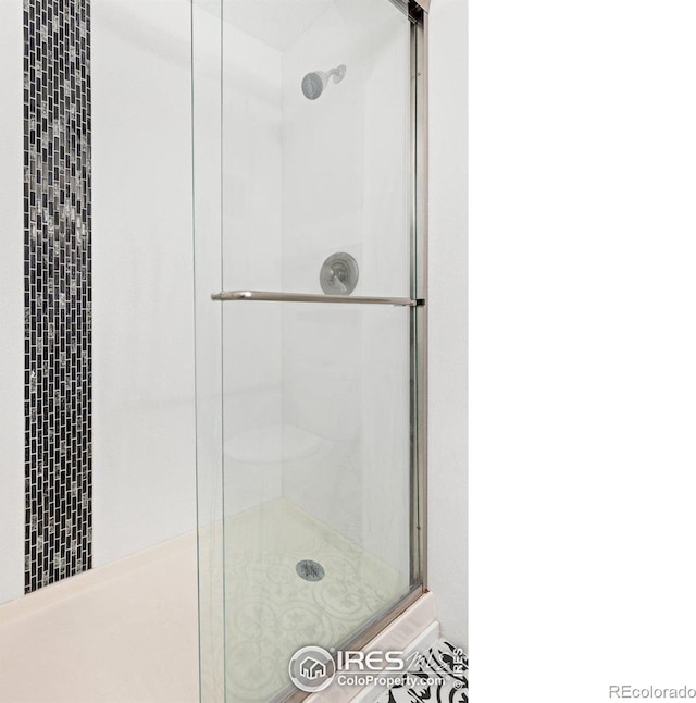 bathroom with a shower stall