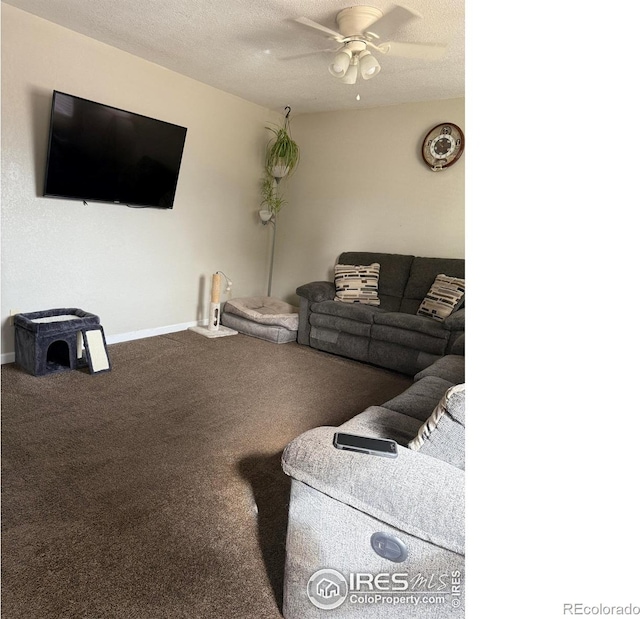 carpeted living room featuring baseboards, a textured ceiling, and ceiling fan