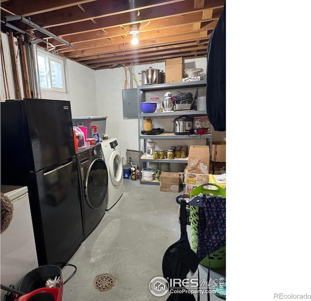 below grade area with freestanding refrigerator and washing machine and clothes dryer