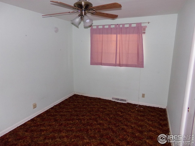 carpeted empty room featuring a ceiling fan, visible vents, and baseboards